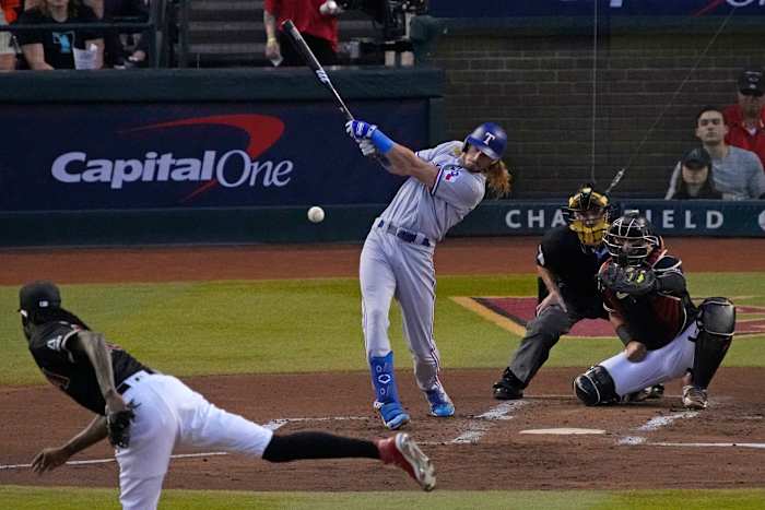 Oct 31, 2023; Phoenix, Arizona, USA; Texas Rangers left fielder Travis Jankowski (16) hits a single against the Arizona Diamondbacks during the second inning in game four of the 2023 World Series at Chase Field. Mandatory Credit: Rick Scuteri-USA TODAY Sports